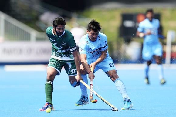 A Pakistan and India player battle for possession during a match in the World Hokcey League