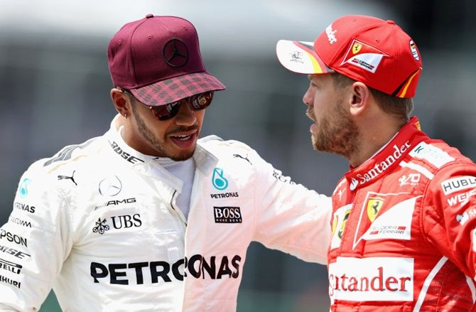 Lewis Hamilton of Great Britain and Mercedes GP talks with Sebastian Vettel of Germany and Ferrari