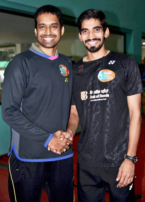 Gopichand greets K Srikanth before a press conference in Hyderabad on Tuesday