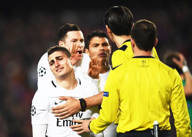 Marco Verratti and Julian Draxler of PSG appeal to the referee as Barcelona are awarded a penalty during the UEFA Champions League Round of 16 second leg match at Camp Nou on Wednesday