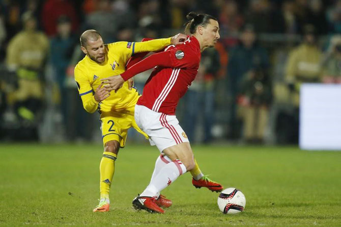 FC Rostov's Timofei Kalachev in action with Manchester United's Zlatan Ibrahimovic during their Europa League Round of 16 first leg match on Thursday