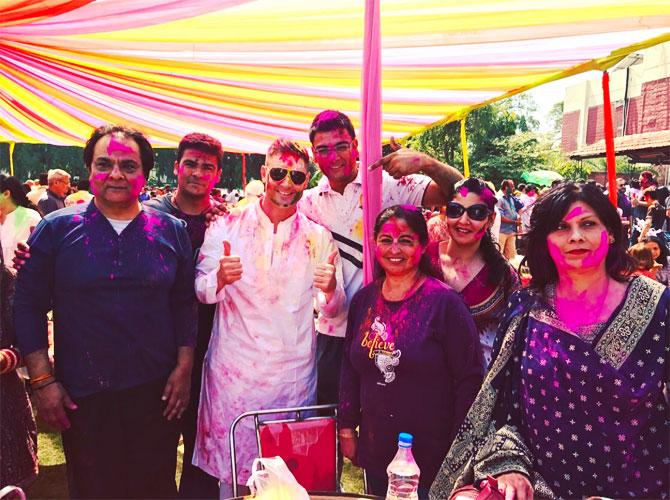 Michael Clarke (centre) gets into the spirit of the festival