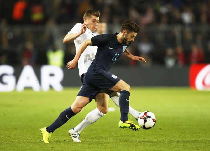 England's Adam Lallana and Germany's Toni Kroos vie for possession