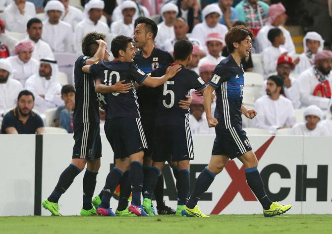 Japan's Yuya Kubo (2L) celebrates with teammates after netting the first goal against United Arab Emirates at Hazza Bin Zayed Stadium in Al Ain City, United Arab Emirates on Thursday