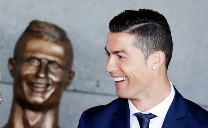 The The questionable statue of Cristiano Ronaldo is seen as the footballer is all smiles at the airport renaming ceremony in Santa Cruz, Funchal, Madeira in Portugal on Wednesday