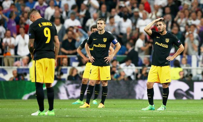 Atletico Madrid's Fernando Torres, Gabi and Koke look dejected after Real Madrid's third goal during their Champions League semi-final first leg match at the Santiago Bernabeu in Madrid on Tuesday