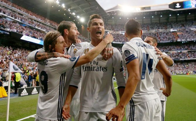 Real Madrid players celebrate after Cristiano Ronaldo scores the opening goal against Atletico Madrid during the Champions League first leg semi-final at the Santiago Bernabeu in Madrid on Tuesday