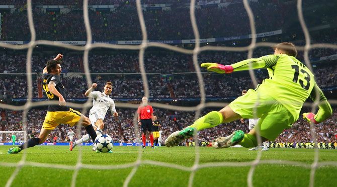 Real Madrid's Cristiano Ronaldo scores his hat-trick past goalkeeper Atletico Madrid's 'keeper Jan Oblak