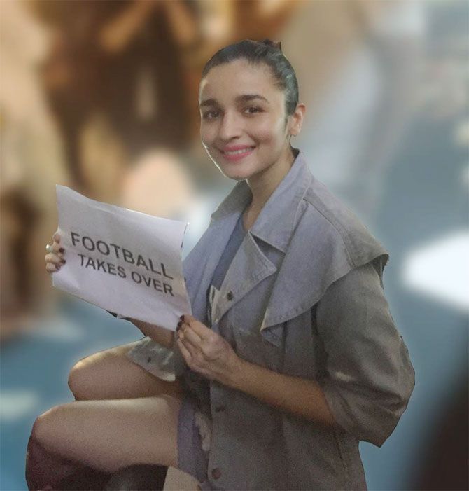 Alia Bhatt poses with a note in support of football