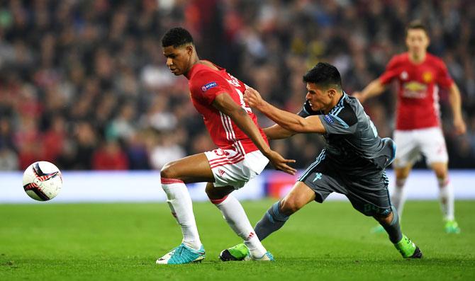 Celta Vigo's Facundo Roncaglia challenges Manchester United's Marcus Rashford as they vie for possession