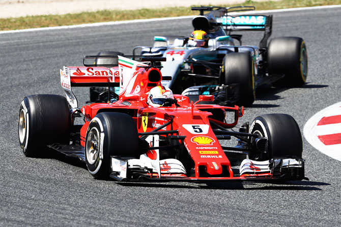 Ferrari's Sebastian Vettel leads Mercedes' Lewis Hamilton on the track