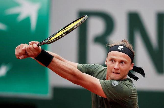 Slovakia's Jozef Kovalik in action during his first round match against Switzerland's Stan Wawrinka