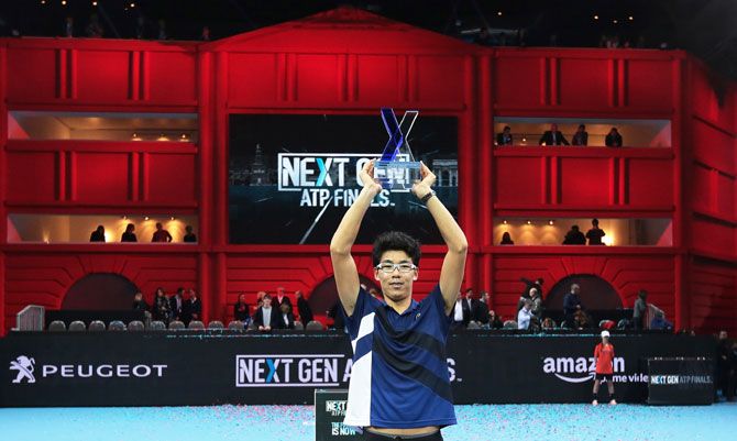 South Korea's Hyeon Chung celebrates with the trophy after victory against Russia's Andrey Rublev in the men's final of the Next Gen ATP Finals in Milan, Italy, on Saturday