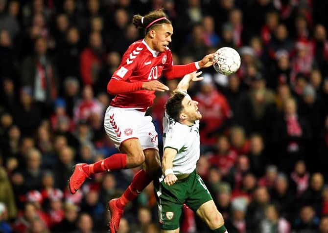 Denmark's Yussuf Yurary Poulsen and Ireland's Stephen Ward in an aerial duel as they vie for possession at Telia Parken in Copenhagen in Denmark on Saturday