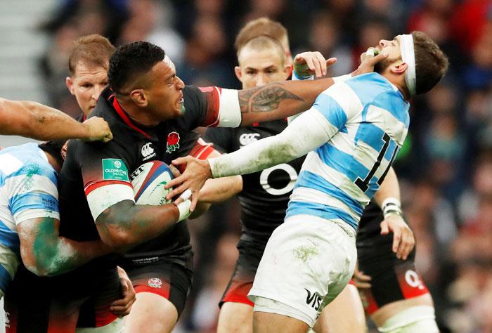 England's Nathan Hughes and with Argentina's Ramiro Moyano Joya in action during their autumn series Rugby Union match in England on Saturday