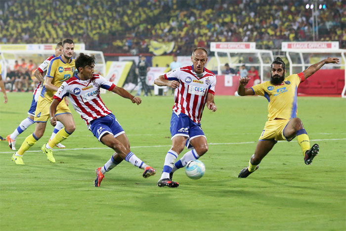 Kerala Blasters' Sandesh Jhinghan (right) attempts to block ATK players during their Indian Super League match in Kochi on Friday