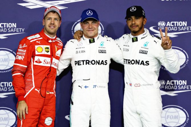 Finland and Mercedes GP's Valtteri Bottas, Great Britain and Mercedes GP's Lewis Hamilton and Germany and Ferrari's Sebastian Vettel pose for a photo in parc ferme during qualifying for the Abu Dhabi Formula One Grand Prix at Yas Marina Circuit in Abu Dhabi, United Arab Emirates, on Saturday