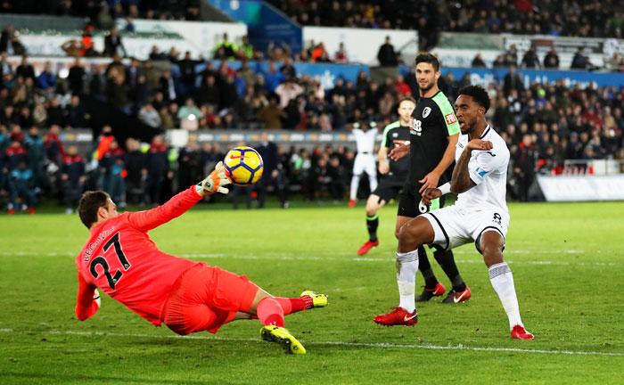 Swansea City's Leroy Fer in action with Bournemouth's Asmir Begovic during their match at Liberty Stadium in Swansea