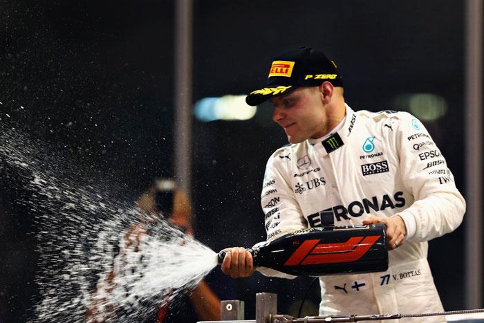 Race winner Valtteri Bottas of Finland and Mercedes GP celebrates on the podium after the Abu Dhabi Formula One Grand Prix at Yas Marina Circuit in Abu Dhabi on Sunday