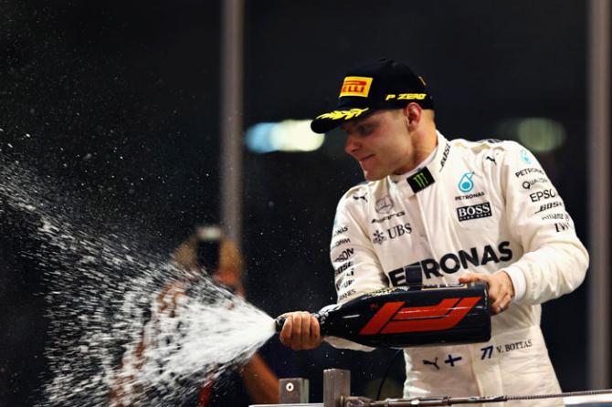 Race winner Valtteri Bottas of Finland and Mercedes GP celebrates on the podium after the Abu Dhabi Formula One Grand Prix at Yas Marina Circuit in Abu Dhabi on Sunday