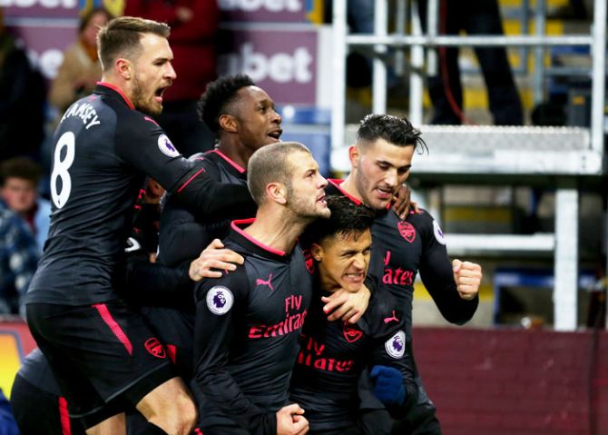 Arsenal's Alexis Sanchez celebrates scoring a goal with teammates Aaron Ramsey, Jack Wilshere, Danny Welbeck and Sead Kolasinac during their English Premier League match against Burnley at Turf Moor in Burnley on Sunday