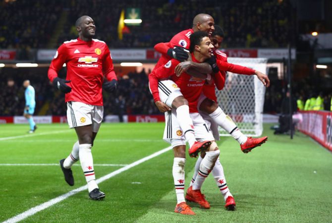 Manchester United's Jesse Lingard celebrates with teammates Ashley Young and Romelu Lukaku as he scores the team's fourth goal during their match against Watford at Vicarage Road in Watford on Tuesday