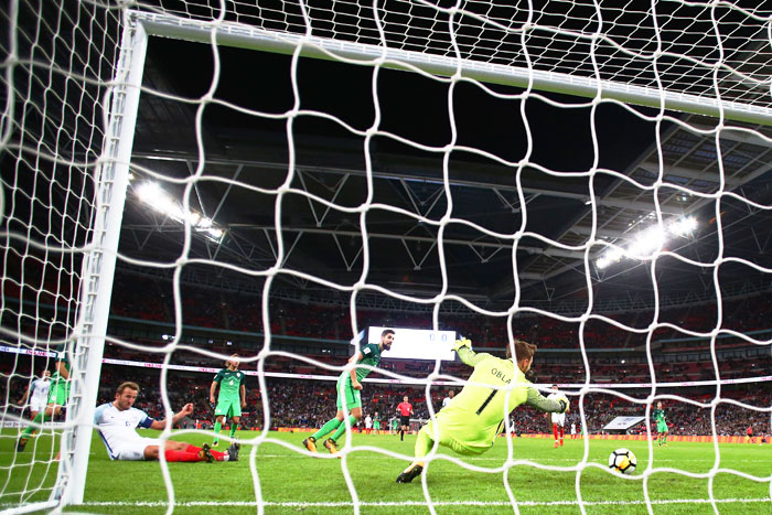 England's Harry Kane (on ground) scores the winner past Slovenia goalkeeper Jan Oblak during their FIFA 2018 World Cup Group F Qualifier at Wembley Stadium in London on Thursday