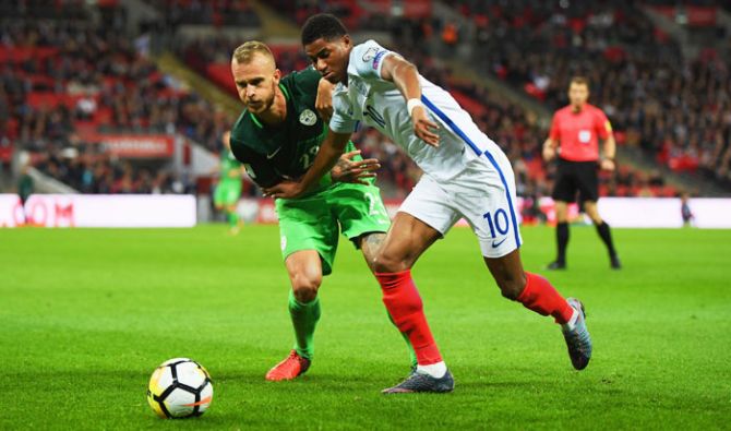 England's Marcus Rashford battles for the ball with Slovenia's Aljaz Struna