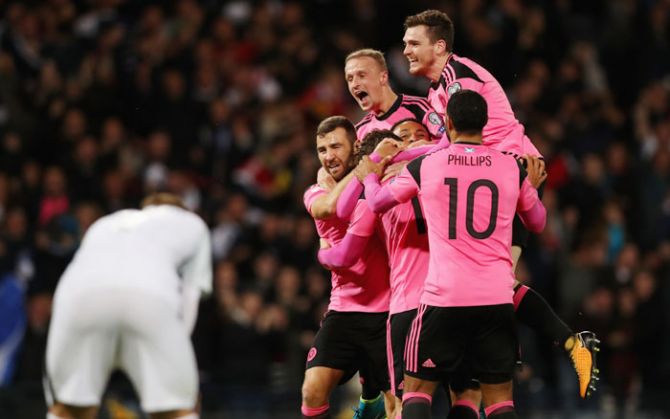 Scotland players celebrate as Martin Skrtel of Slovakia scores an own goal during theirGroup F Qualifier at Hampden Park in Glasgow