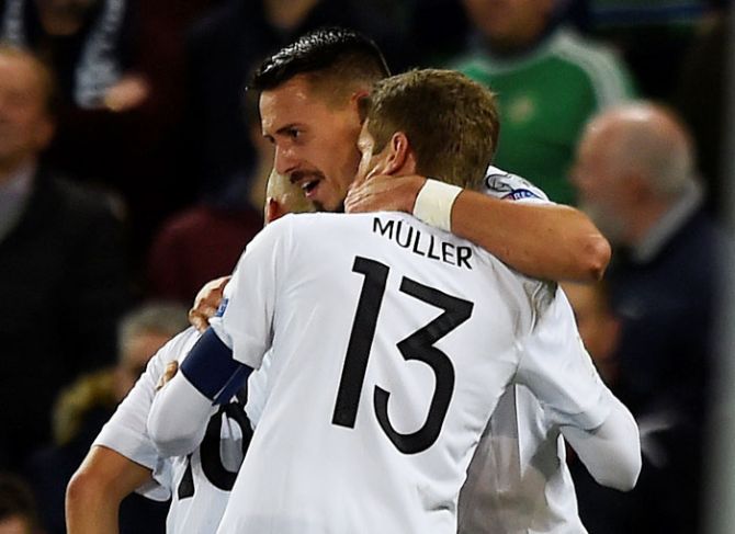 Germany’s Sandro Wagner celebrates with Thomas Muller after scoring their second goal against Northern Ireland during their World Cup qualifier at Windsor Park in Belfast