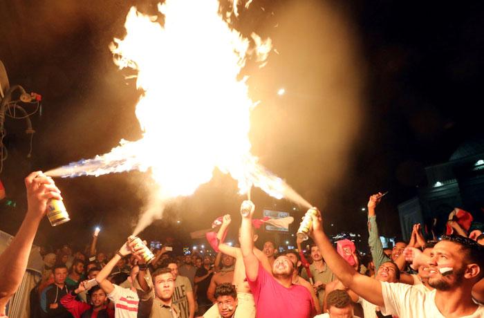 Egyptians celebrate after their football team defeated Congo in the World Cup qualifiers in Cairo, Egypt on Sunday