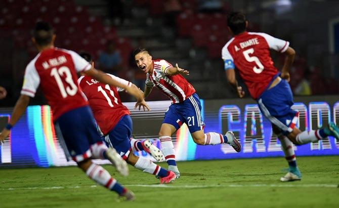 Paraguay's Alan Rodriguez, centre, celebrates after scoring a goal against New Zealand on Monday