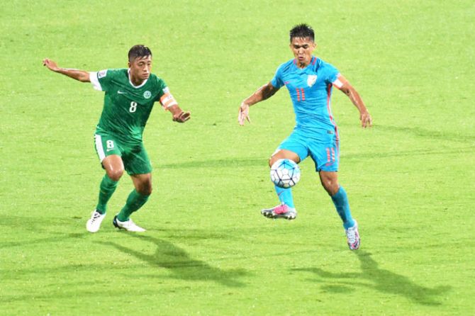 India's Sunil Chettri and Macau's Cheang Cheng vie for the ball during their AFC Asian Cup qualifier at Kanteerava Stadium in Bengaluru on Wednesday