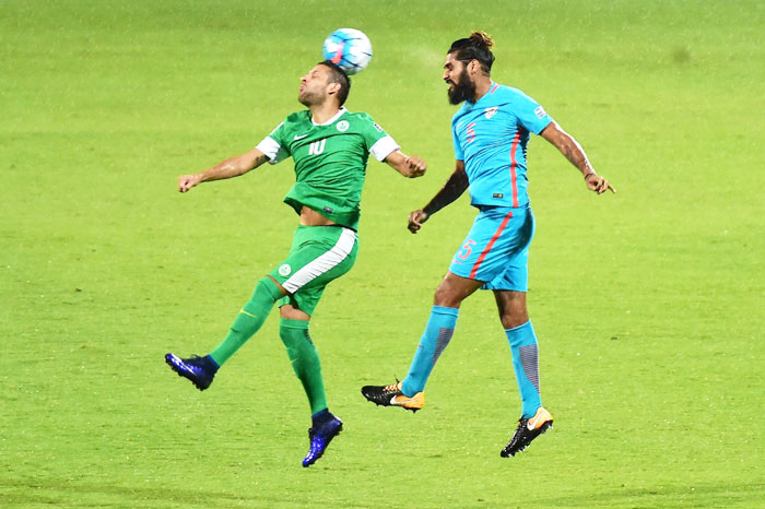 India's Sandesh Jhinghan and Macau's Nicholas vie for the ball