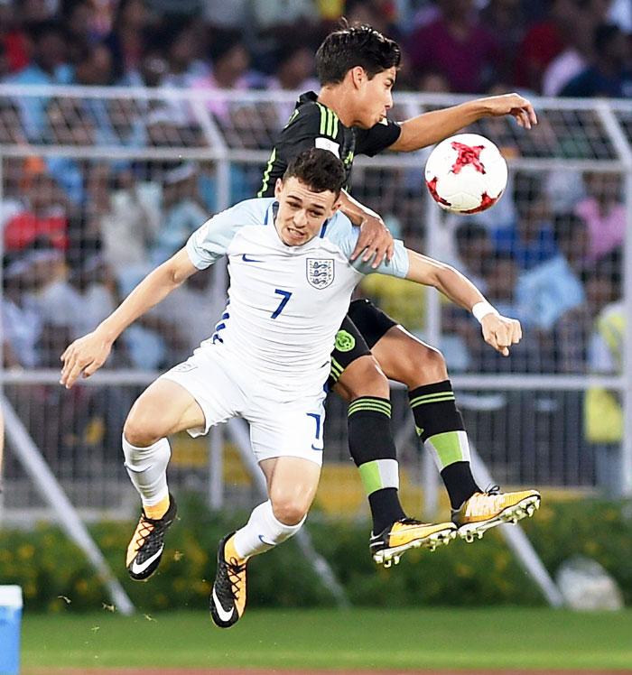 Players from England and Mexico vie for an aerial ball during their Under-17 World Cup Group match in Kolkata on Wednesday