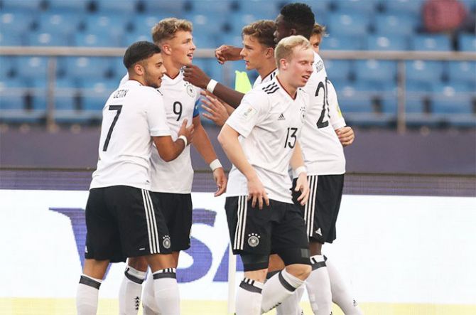 Germany players celebrate with captain Jann-Fiete Arp after scoring the opening goal against Colombia during their FIFA Under-17 World Cup pre-quarterfinal in New Delhi on Monday