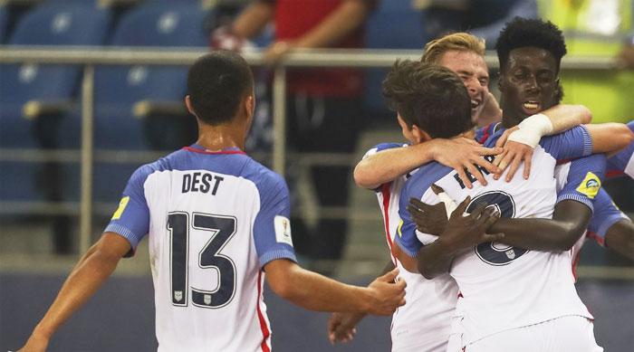 Players of the United States of America celebrate a goal against Paraguay during their Under-17 World Cup pre-quarterfinal in New Delhi on Monday