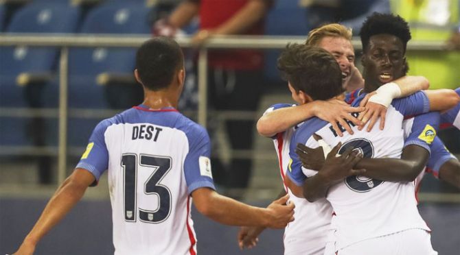 Players of the United States of America celebrate a goal against Paraguay during their Under-17 World Cup pre-quarterfinal in New Delhi on Monday