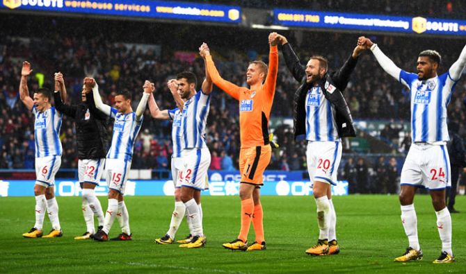 Huddersfield Town players celebrate after comprehensively beating Manchester United