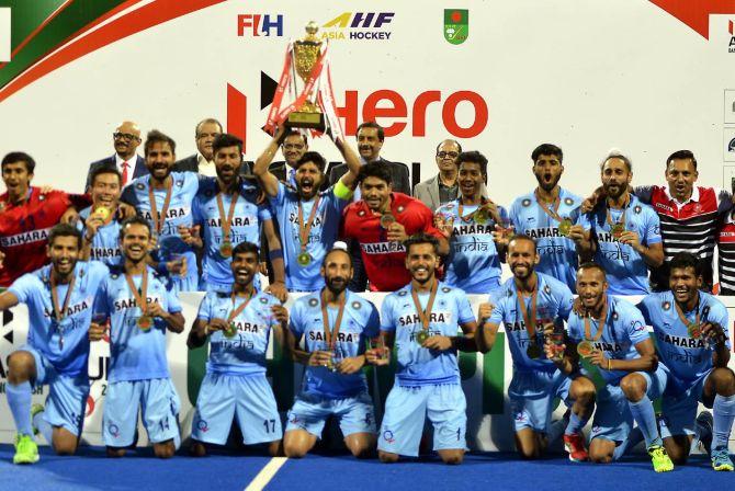 India's players celebrate with the Asia Cup after beating Malaysia in the final