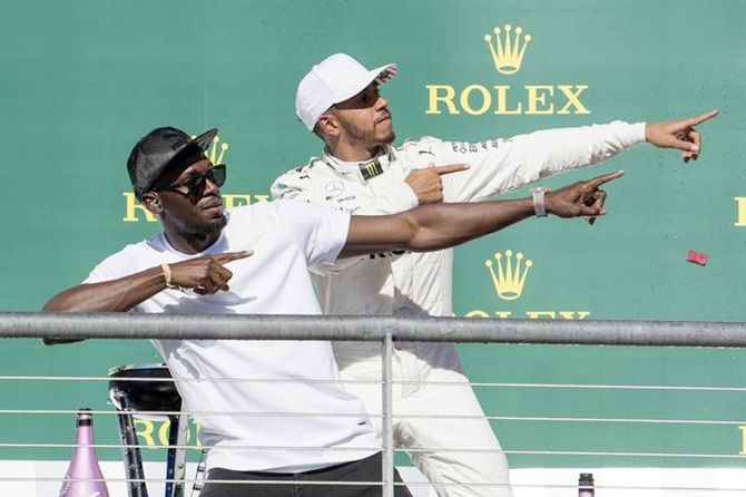 Mercedes driver Lewis Hamilton of Great Britain poses with Olympic sprint champion Usain Bolt after winning the United States Grand Prix at the Circuit of the Americas.