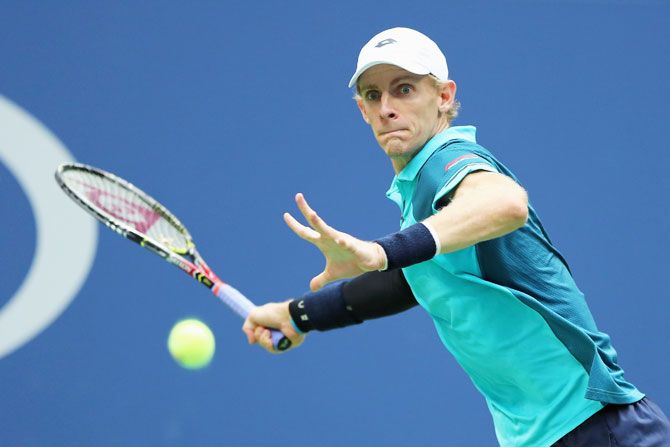 South Africa's Kevin Anderson plays a return against Spain's Pablo Carreno Busta