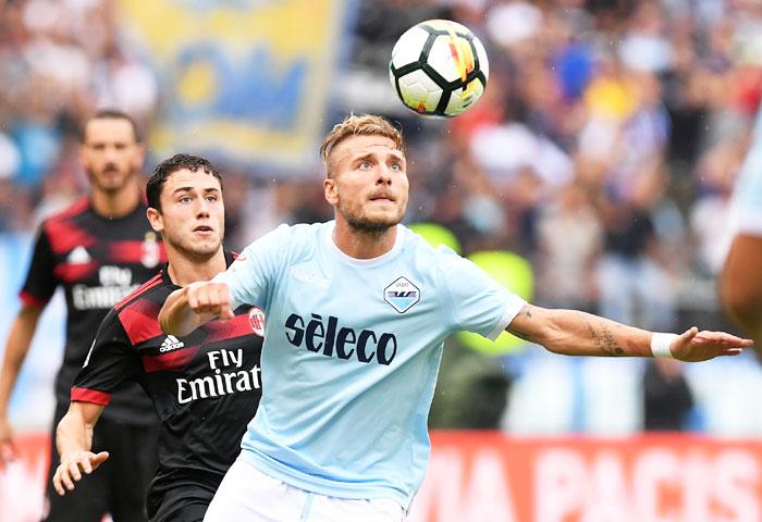 Lazio’s Ciro Immobile (right) vies for the ball with AC Milan's Davide Calabria