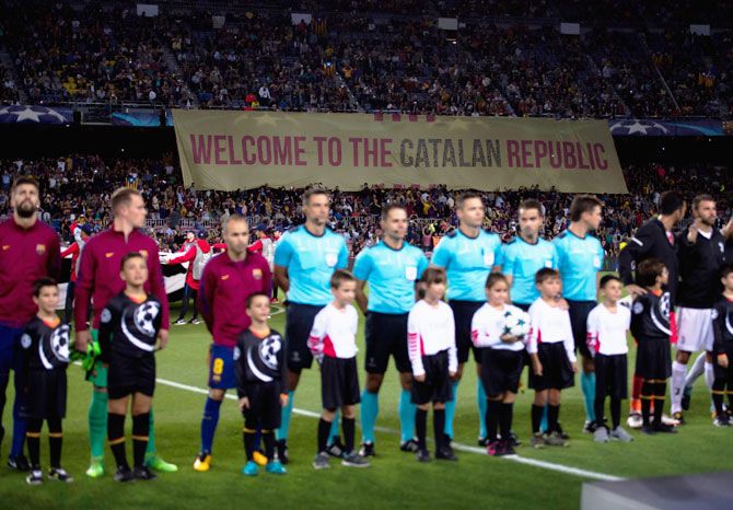 Fans display a banner as the teams and officals line up prior to the UEFA Champions League Group D match between FC Barcelona and Juventus at Camp Nou on Tuesday