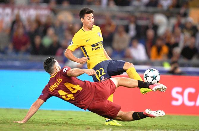 Atletico Madrid's Nicolas Gaitan challenges AS Roma's Konstantinos Manolas during their match at Stadio Olimpico in Rome