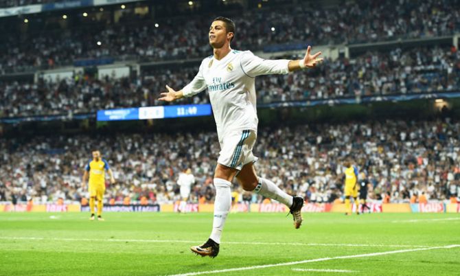 Real Madrid's Cristiano Ronaldo celebrates scoring the first goal against APOEL Nikosia during their UEFA Champions League group H match at Estadio Santiago Bernabeu in Madrid on Wednesday