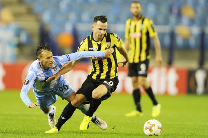 SS Lazio's Alessandro Murgia competes for the ball with Vitesse's Thomas Bruns during their UEFA Europa League Group K match at Gelredome in Arnhem, Netherlands, on Thursday