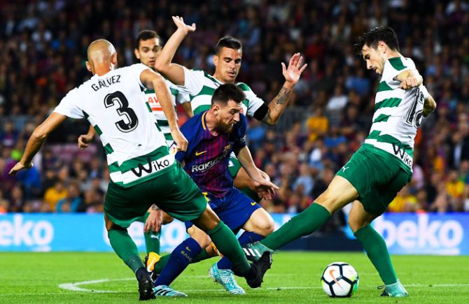 FC Barcelona's Lionel Messi is challenged by four Eibar players