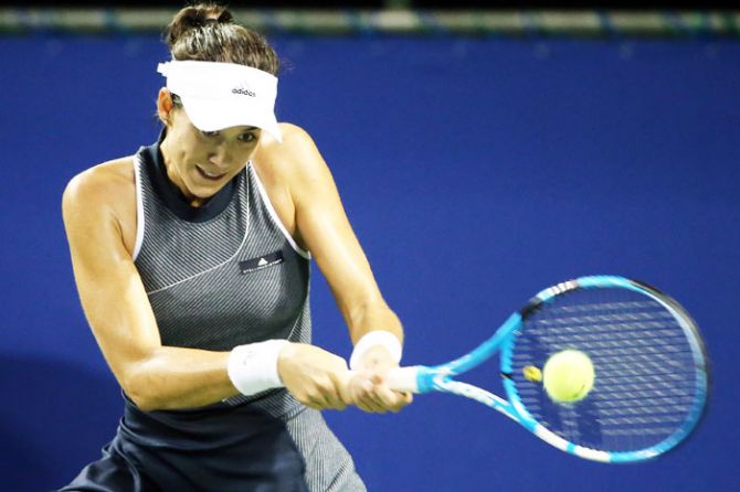 Spain's Garbine Muguruza plays a backhand in her quarter-final match against France's Caroline Garcia during day five of the Toray Pan Pacific Open Tennis At Ariake Coliseum in Tokyo, on Friday