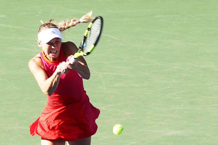 Denmark's Caroline Wozniacki plays a forehand in her semi-final match against Spain's Garbine Muguruza on day six of the Toray Pan Pacific Open Tennis At Ariake Coliseum in Tokyo on Saturday